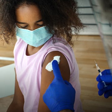 A girl receiving a booster dose of the COVID-19 vaccine, which new data from Pfizer suggest signific...