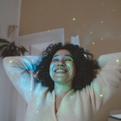 A woman with a star projector in her room. How to read your horoscope correctly, according to an ast...