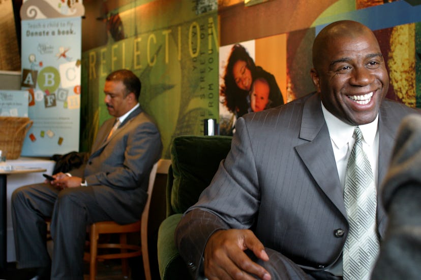 Earvin "Magic" Johnson beams as he talks with a well-wisher during the opening of a new Starbucks at...