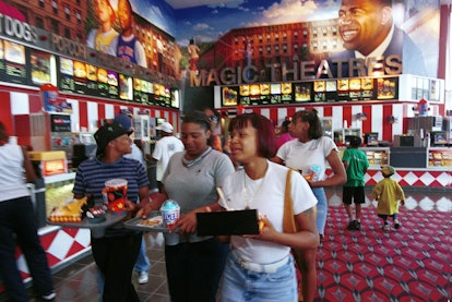 372768 02: Visitors buy food from the concession at Magic Johnson Theatres inside the new Harlem USA...