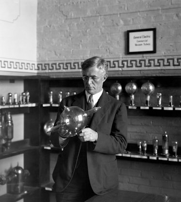 In a 1930 portrait, GE chemist Dr. Irving Langmuir holds a pliotron, a type of vacuum tube he helped...