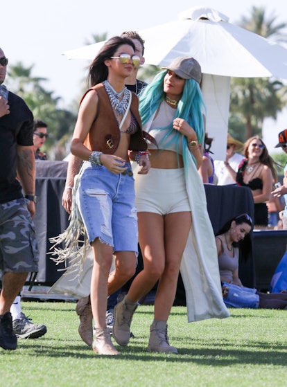Kendall Jenner is seen with sister Kylie Jenner wearnig a brown vest, long denim shorts, and python ...