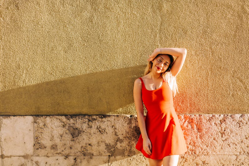 woman posing in front of a wall