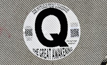 Sign posted by QAnon, or simply Q, is a discredited American far-right conspiracy theory alleging th...