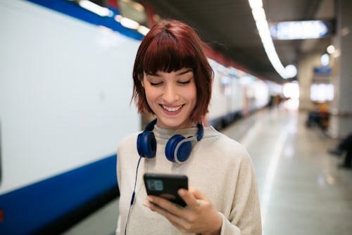 A woman checks out Communities on WhatsApp on her phone.