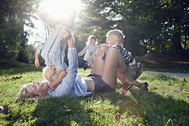 Mom playing with young kids trying to be present