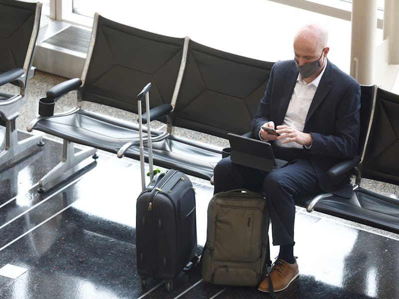 A traveler wearing a mask is seen at Ronald Reagan Washington National Airport in Arlington, Virgini...