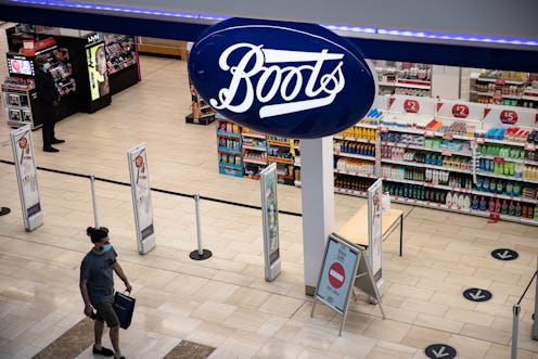 LONDON, UNITED KINGDOM - 2021/05/29: A man walks past the Boots, a British health and beauty retaile...