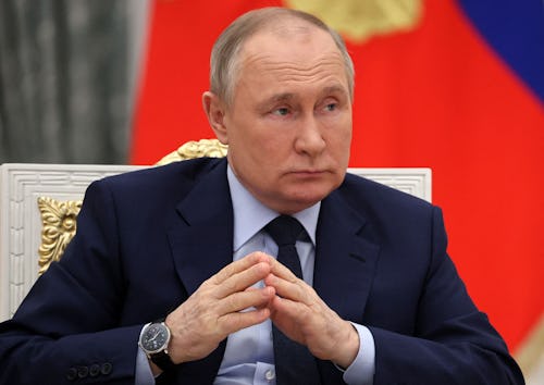 Russian President Vladimir Putin joins his hands as he holds a meeting of the Russia - Land of Oppor...