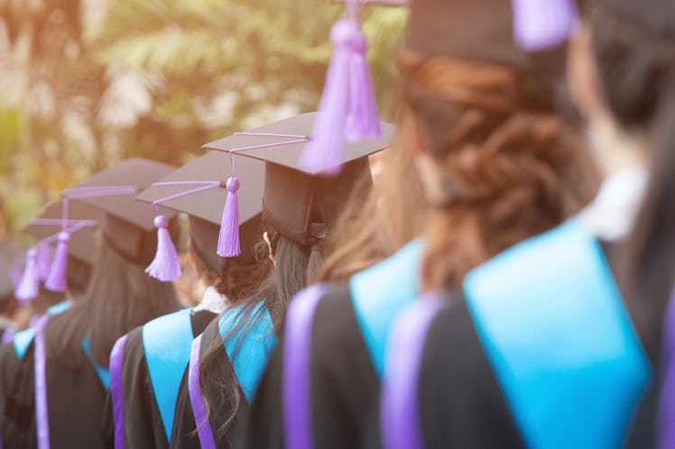 close up hat young women backside group crowd of new graduates during commencement. Concept educati...