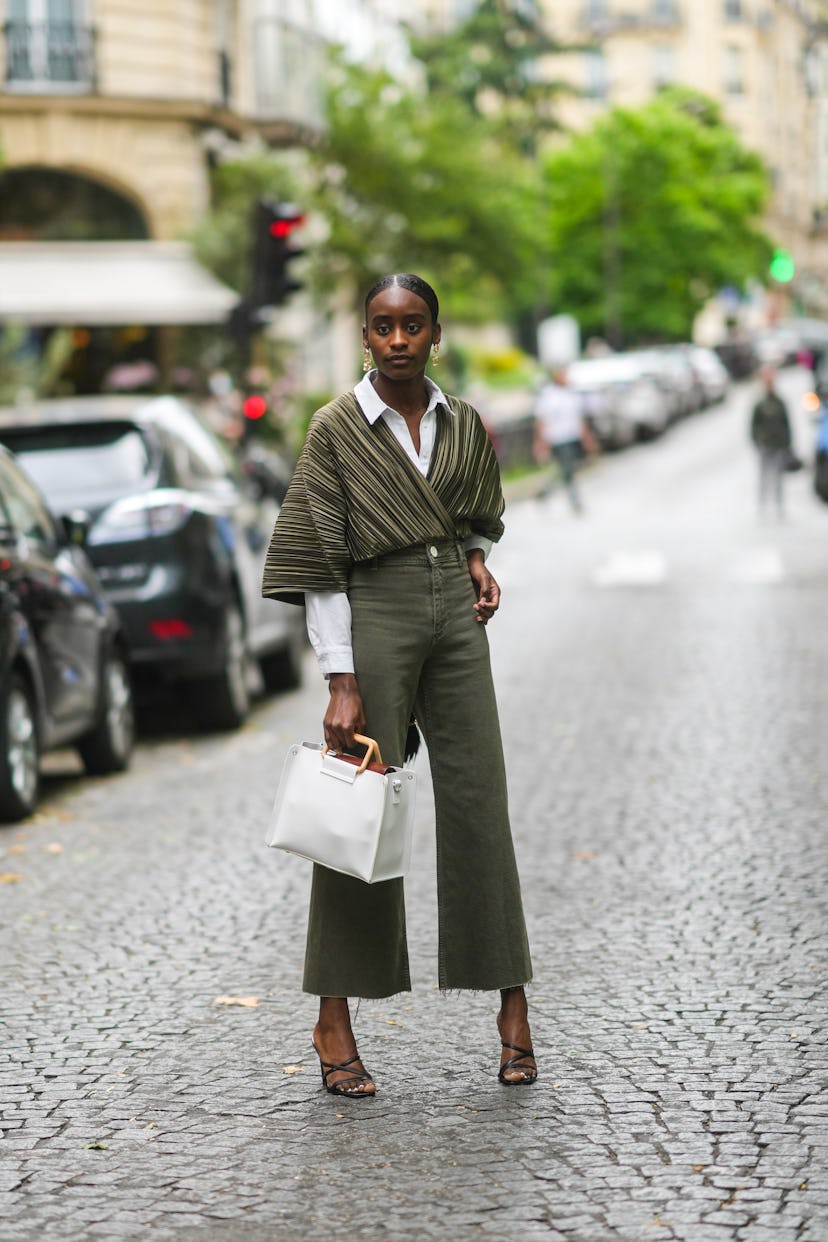 Woman wearing army green top and pants with strappy mules