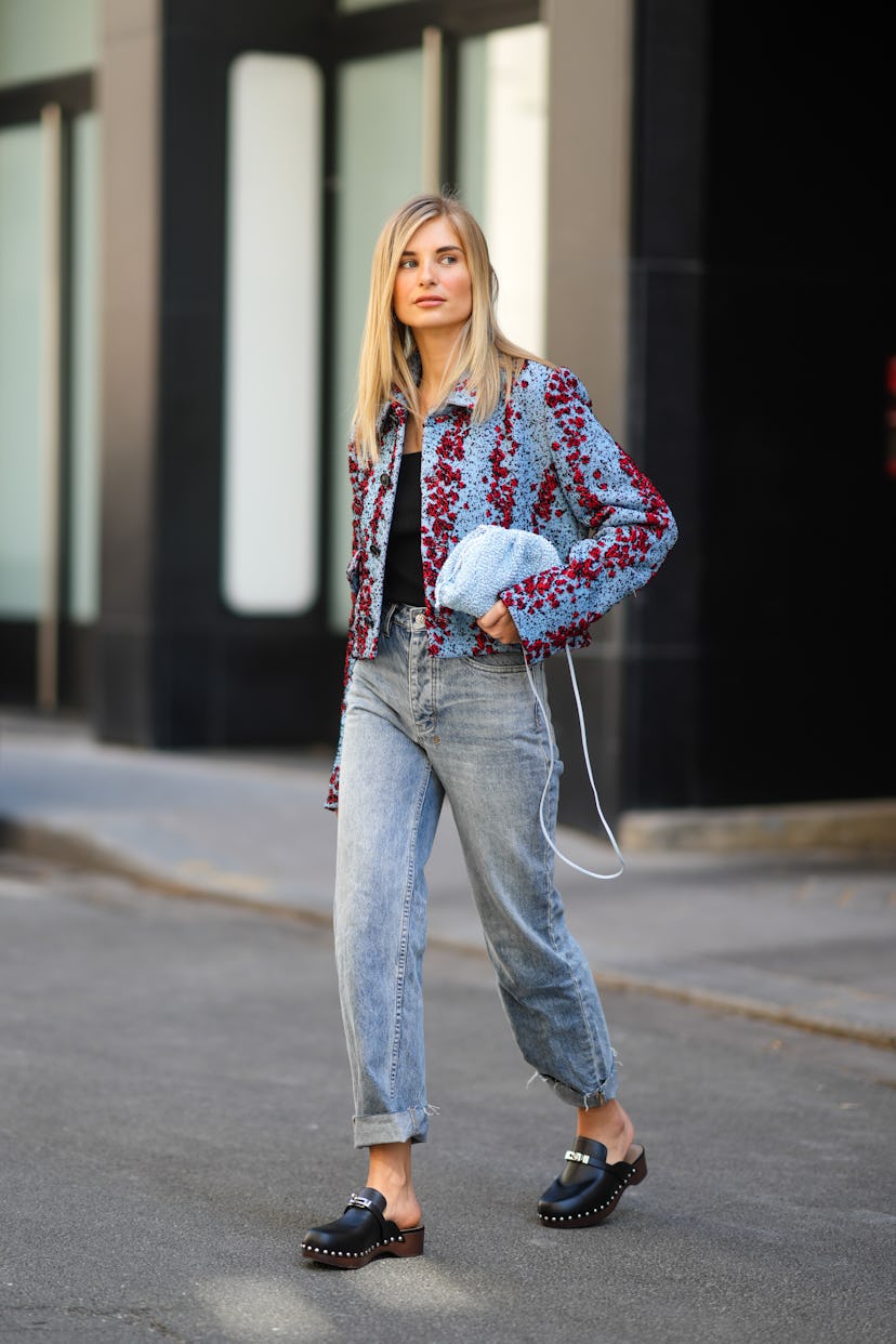 Xenia Adonts wearing jeans, a cropped jacket, and clogs