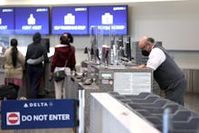 SAN FRANCISCO, CALIFORNIA - APRIL 19: A Delta Airlines worker wears a mask while waiting for custome...