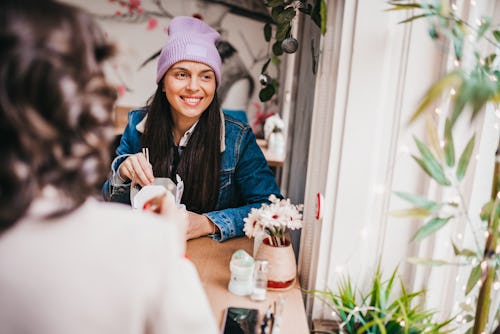 Two women have fun at brunch. Here's your April 22 zodiac sign daily horoscope for 2022.