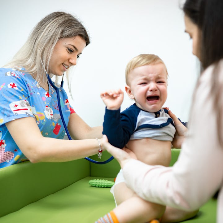 A doctor examines a baby for potential signs of hepatitis. which the CDC just alerted pediatricians ...