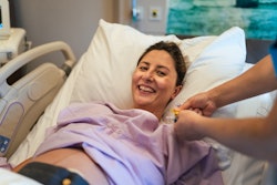 Young pregnant woman in the hospital ward and ready to delivery a baby.
