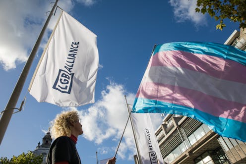 An activist holds a transgender pride flag at a protest by Transgender Action Block and supporters o...
