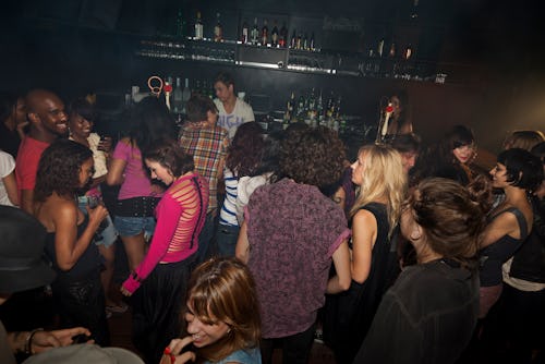 crowded bar full of ethnically diverse group of people