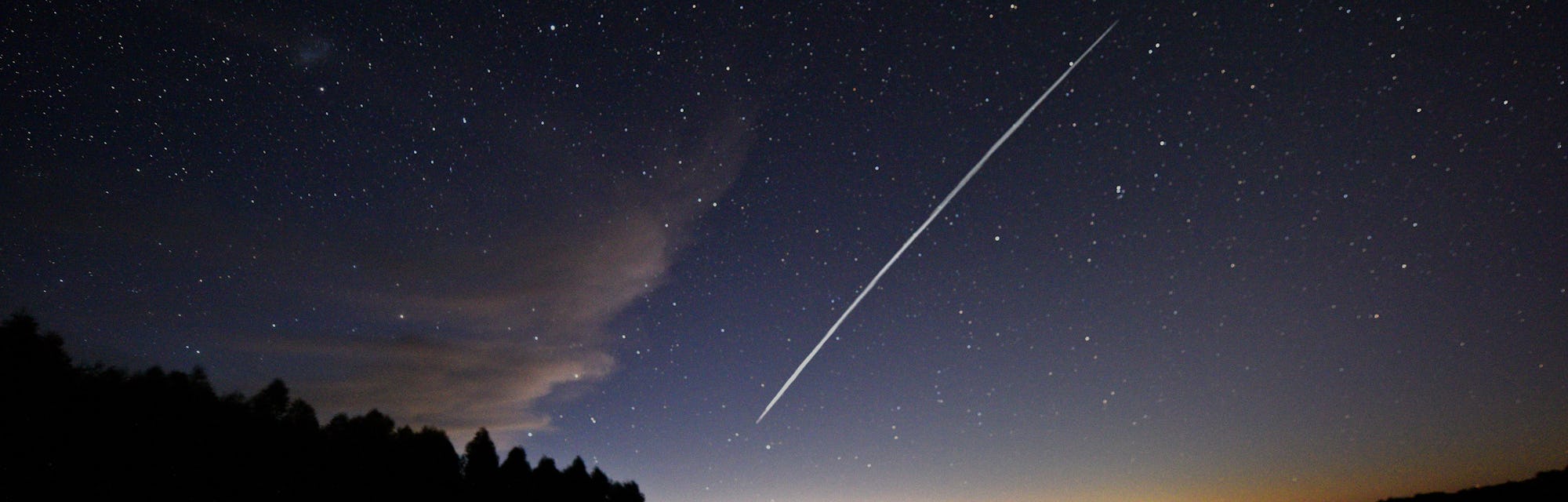 This long-exposure image shows a trail of a group of SpaceX's Starlink satellites passing over Urugu...