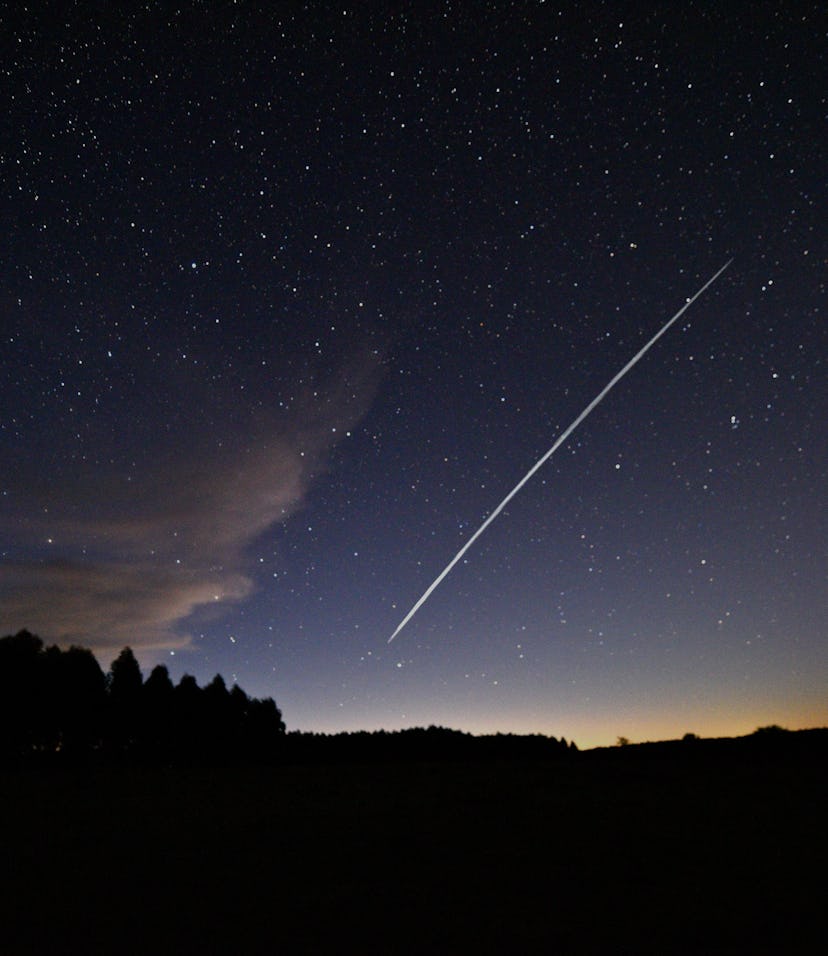 This long-exposure image shows a trail of a group of SpaceX's Starlink satellites passing over Urugu...
