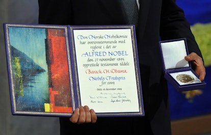 Nobel Peace Prize laureate, US President Barack Obama holds his diploma and medal during the Nobel P...