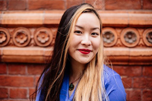 Beautiful young Asian woman headshot on street in London