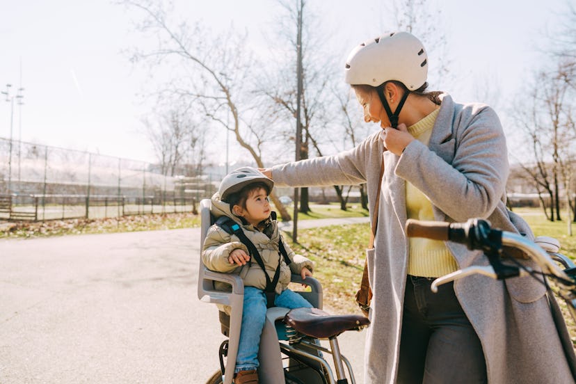 Photo of a little girl and her mom commute to kindergarten by bicycle, a moment to write a mother's ...