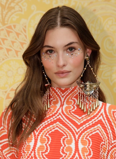 Grace Elizabeth wearing rhinestone makeup poses in the backstage of the Etro fashion show during the...