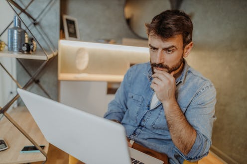 Young man using his laptop at home