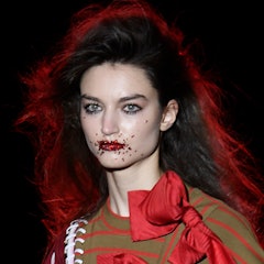 A model wearing a glitter lip walks the runway at the Brain & Beast fashion show during Mercedes Ben...