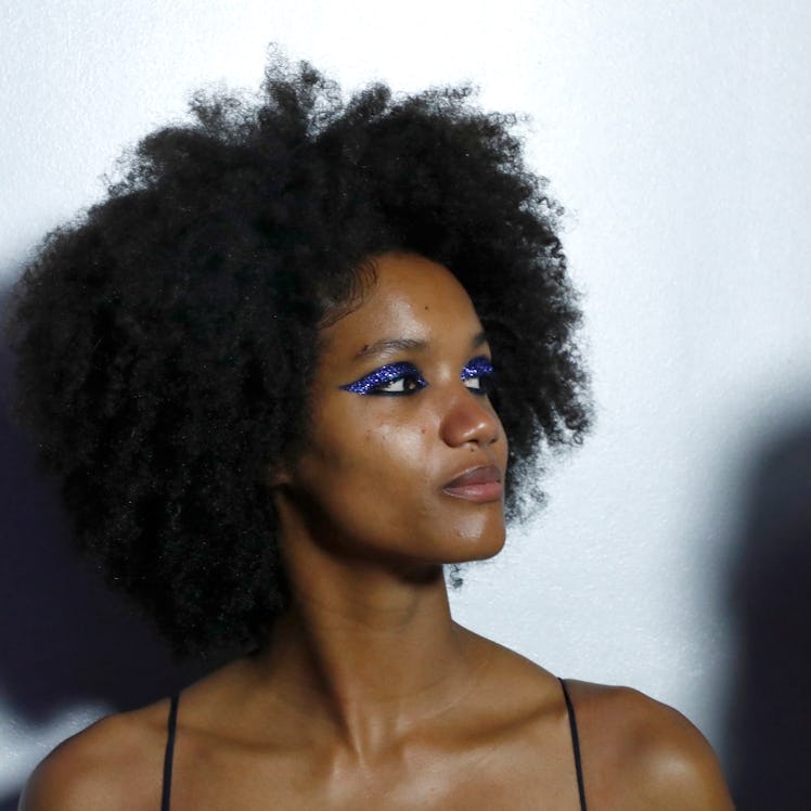 A model wearing glitter eyeshadow prepares backstage at TRESemme x LaQuan Smith during New York Fash...