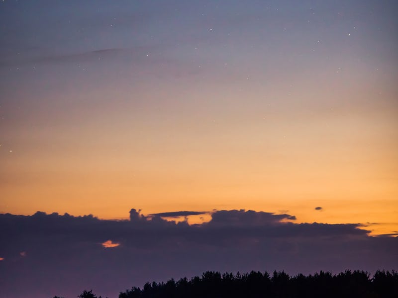 Comet in the night sky. Summer starry sky. Stars on the sky. Beautiful night landscape. Long exposur...