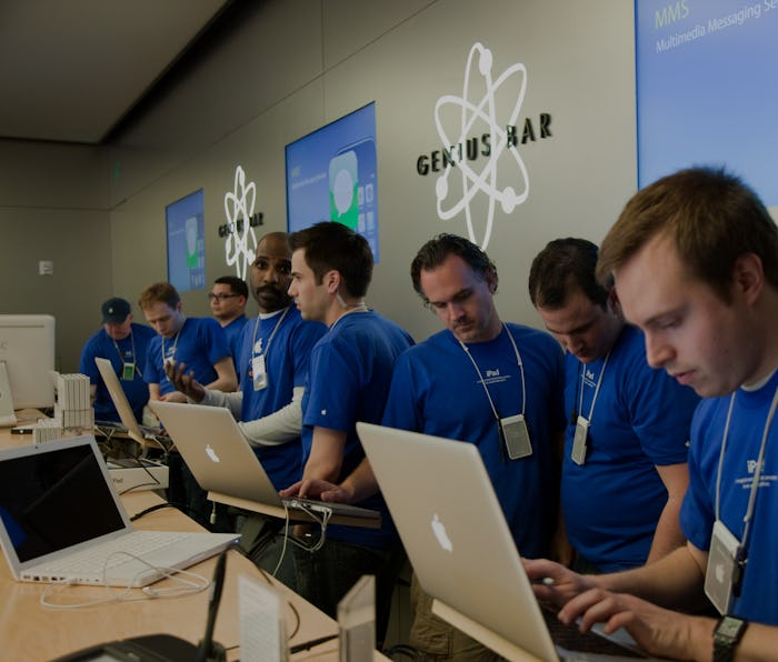Apple employees work behind the Genius Bar at the Apple store in Bethesda, MD. (Photo by Brooks Kra...