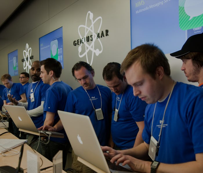 Apple employees work behind the Genius Bar at the Apple store in Bethesda, MD.  (Photo by Brooks Kra...