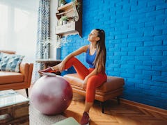 A woman exercising at home would want to try fun cardio workouts for beginners, according to a TikTo...