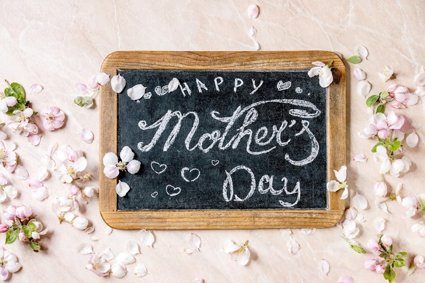 One Mother's Day baby announcement idea is to create and hold a chalkboard sign that announces your ...