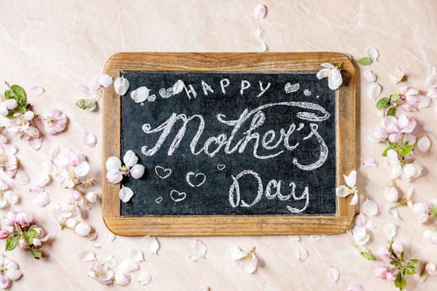 One Mother's Day baby announcement idea is to create and hold a chalkboard sign that announces your ...