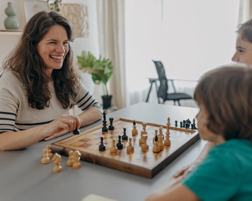 stepmother playing chess with stepkids, mother's day quotes for stepmomos