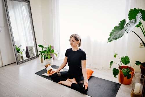 Young girl meditating in lotus pose. Here’s your daily horoscope for April 27, 2022.