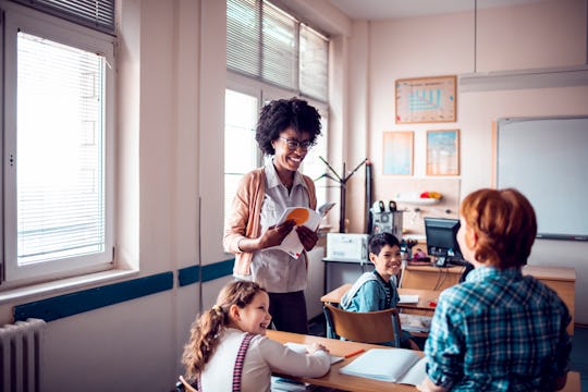 Close up of a teacher helping her class with schoolwork during teacher appreciation week