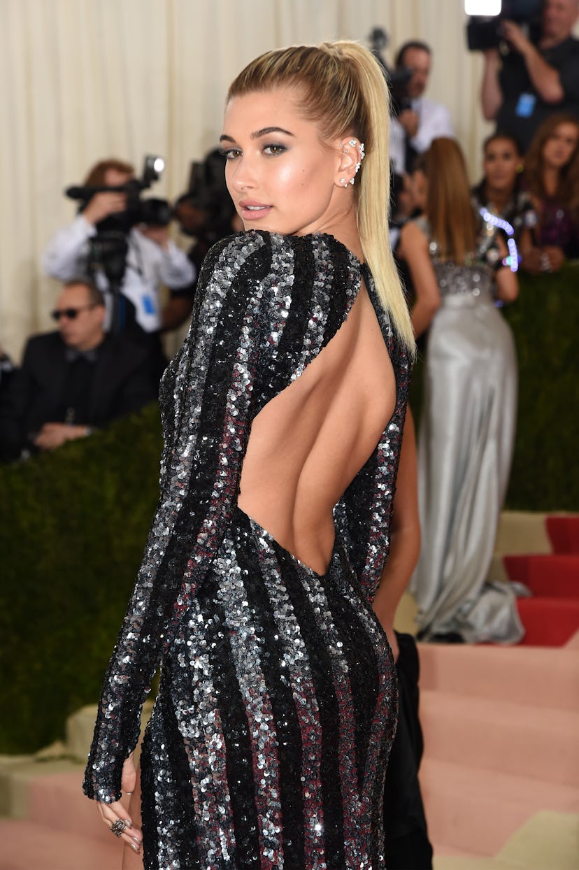 Hailey Bieber's best Met Gala hairstyles, including a pink bob haircut, beachy waves, and a barbie p...