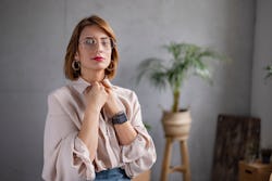 Portrait of a young woman standing in her apartment. The life path 1 meaning explained.