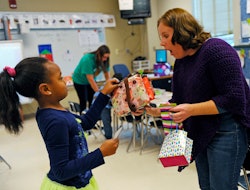 first grader giving a teacher appreciation gift to her teacher