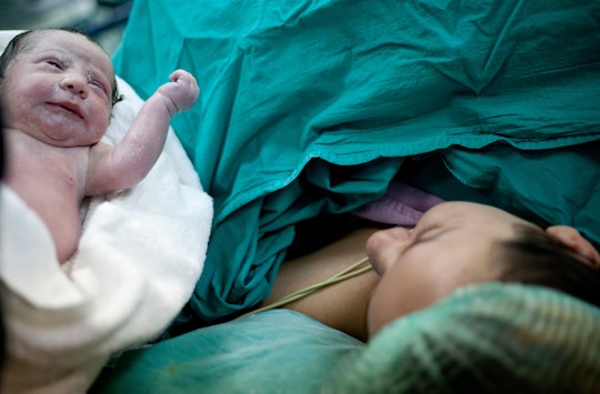 Newborn child and mom after planned c-section