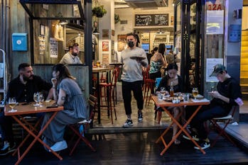 People eat at a restaurant in Hong Kong on April 21, 2022,    after the government eased some of the Co...