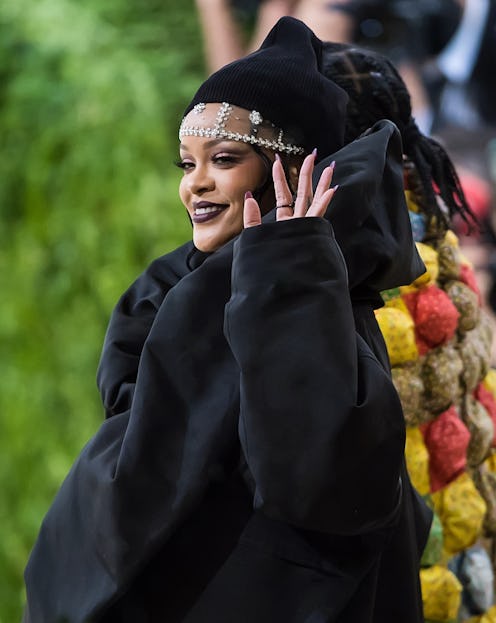 Rihanna attends The 2021 Met Gala Celebrating In America: A Lexicon Of Fashion wearing a black beani...