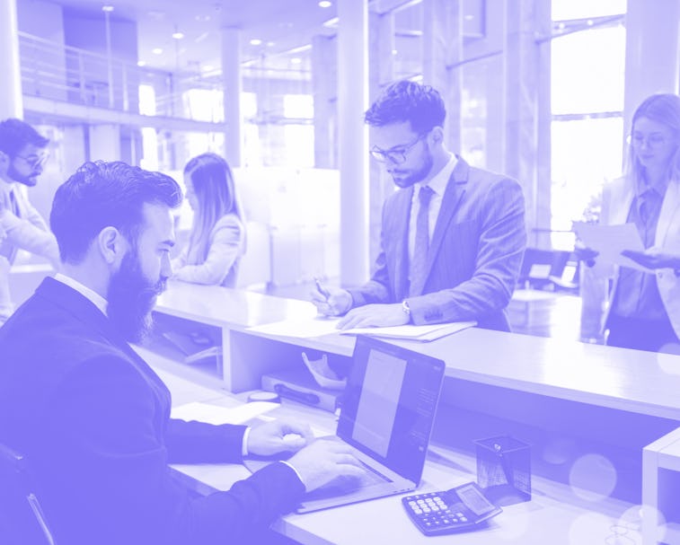 View of young businesspeople in a bank. They're waiting in line in order to talk to their advisors a...