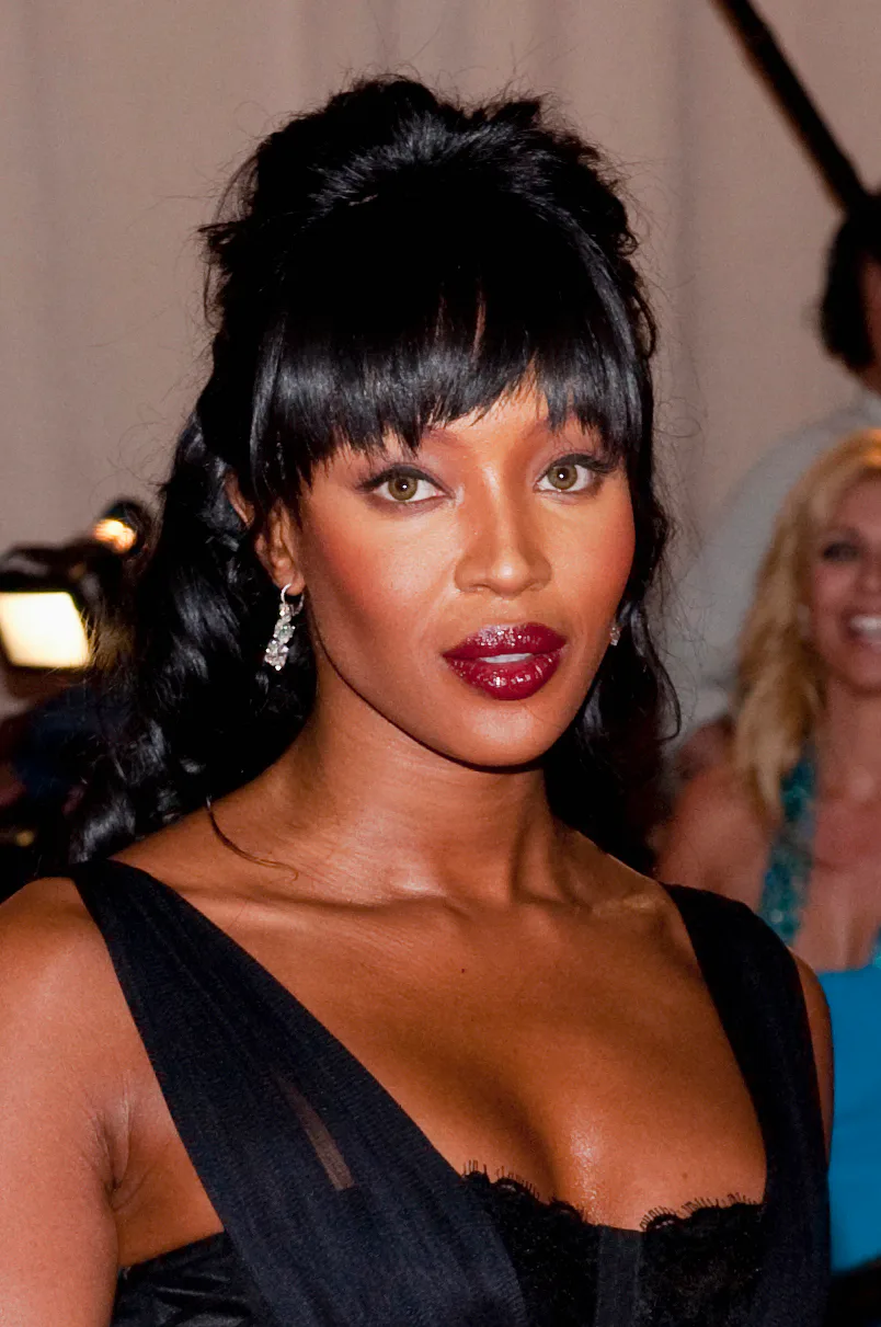 Naomi Campbell wispy bangs and red lip gloss Met Gala 2010