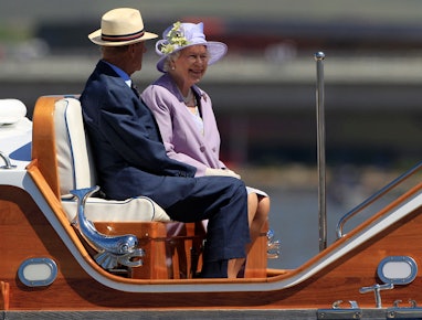 Britain's Queen Elizabeth II (R) and Prince Philip (L) cruise on a navy barge on Lake Burley Griffin...