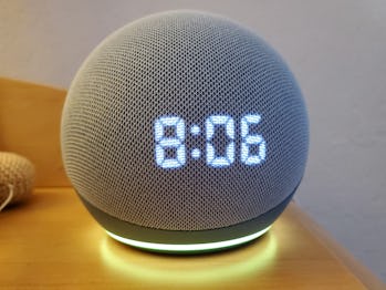 Close-up shot of the Amazon Echo Dot smart speaker with clock and Alexa on a night stand in Lafayett...